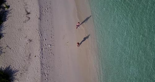 Beautiful lady and man on honeymoon vacation live the dream on beach on white sand background