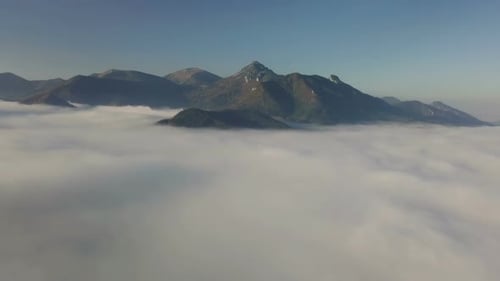 Aerial View of Mountains Emerging from Clouds