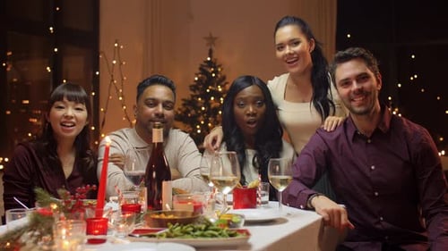 Friends Waving at Christmas Dinner Celebration
