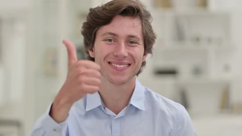 Smiling Young Adult Gives Thumbs Up to Camera