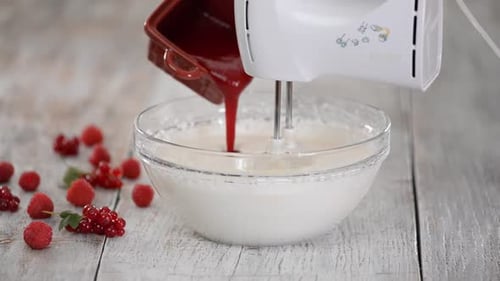 Cream Being Mixed with Berries and Raspberry Jam