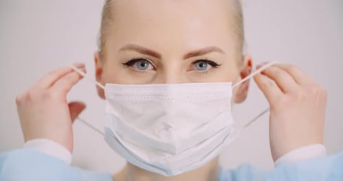 Woman Put Protective Mask on Face