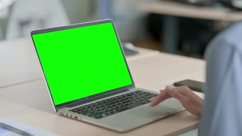 Woman Using Laptop with Green Chroma Key Screen