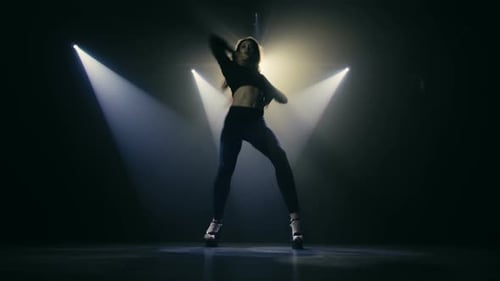 Woman Dances Expressively in Studio with Dramatic Lighting