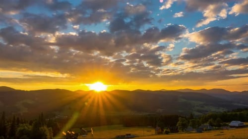 Cloudy Sunrise over Mountain Village with Forest