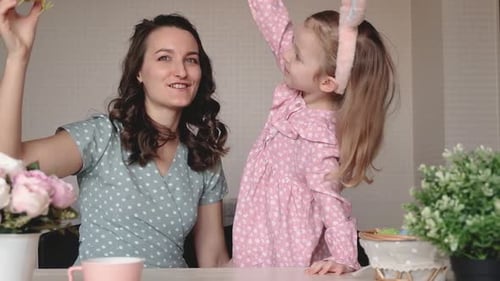 Woman and Child Play with Easter Eggs