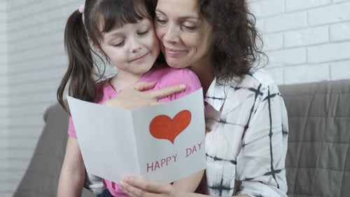 Loving Mother and Daughter Reading Birthday Card