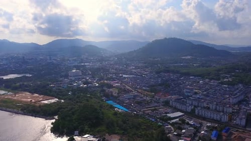 Aerial view of Thai traditional Asian fishing village with boats on sea beach in Phuket island.