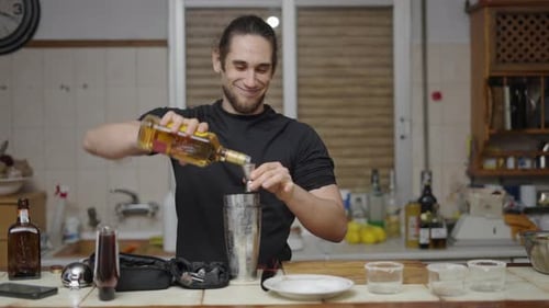 Man Prepares Cocktail in Kitchen