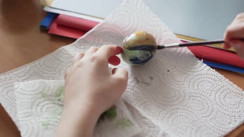 Two Sisters Painting Easter Eggs