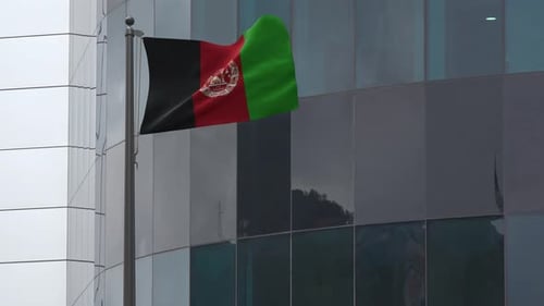 Afghanistan Flag Waving on Modern Building Flagpole