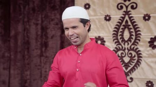 Happy Man Celebrates Success in Traditional Clothing