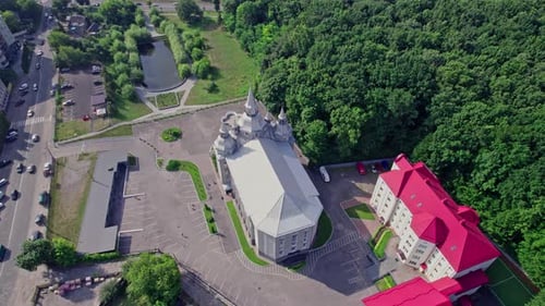 Aerial View of Unique Building Near Forest
