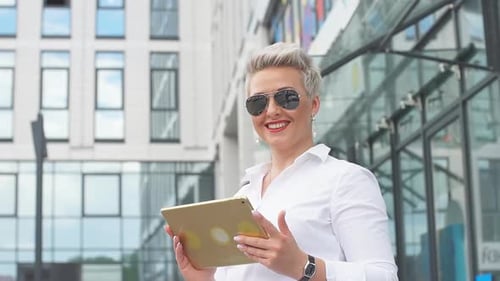 Adult Business Woman with Tablet Pc with Office District on Background