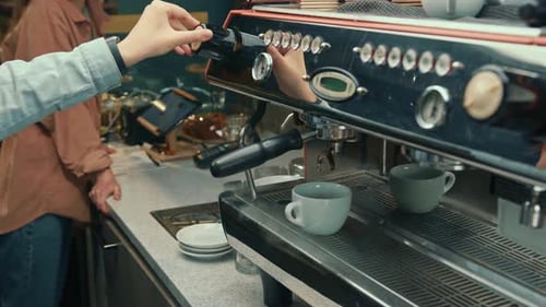 Person Using Professional Espresso Machine in Cafe