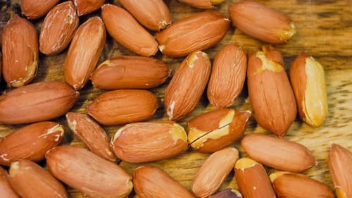 Close Up of Peanuts on a Wooden Surface
