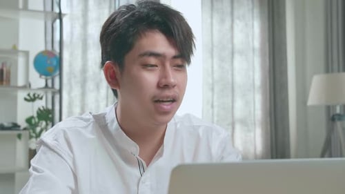 Young Adult Video Call On Laptop At Home