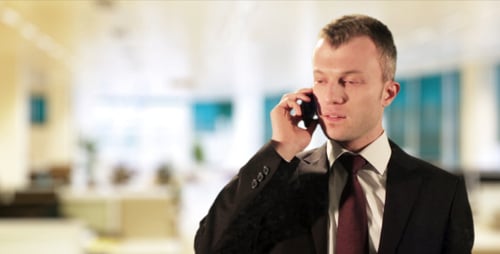 Man in Suit Speaking on Cell Phone in Office