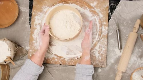 Hands Sifting Flour for Cooking and Baking