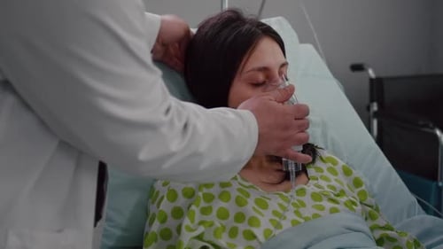Close Up of Medical Doctor Putting Oxigen Mask to Sick Woman