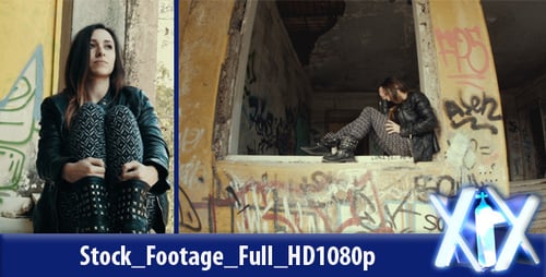 Pensive Woman Sits in Abandoned Graffiti Building