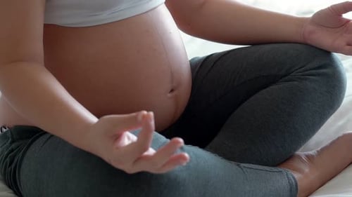 Pregnant Woman Meditating Peacefully at Home