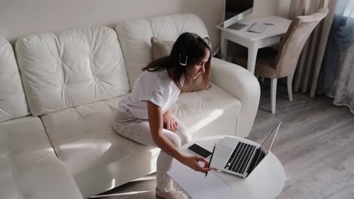 Woman Working on Laptop at Home