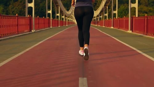 Back View Girl Jogger Trains in the Morning
