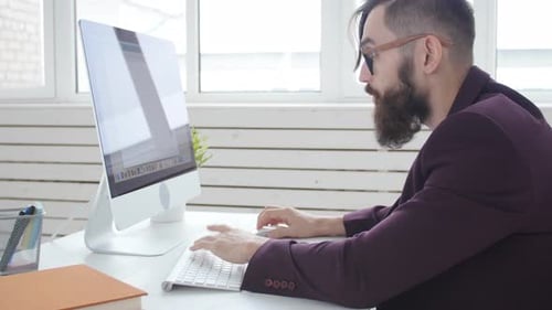 Concept of Freelancing and Work Office. Young Stylish Employee Looking at Computer Monitor During