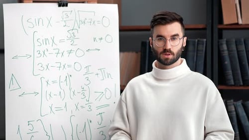 Man Explaining Math Equations on Whiteboard