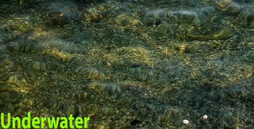 Clear Water Rippling over Rocks on the Shore