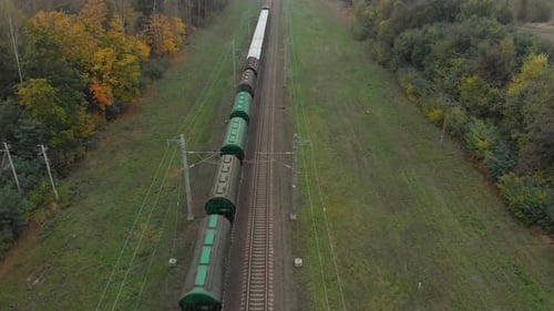 Freight Train Travels Through Rural Autumn Landscape