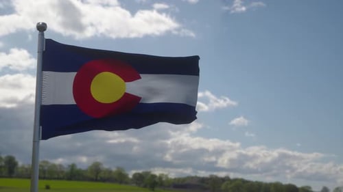 Waving Colorado State Flag on Sunny Day