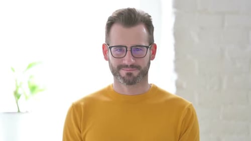 Smiling Man in Glasses and Yellow Sweater