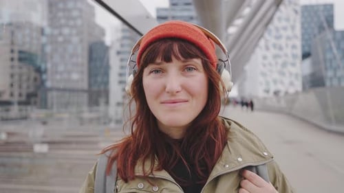 Young Woman Stands on the Streets of the City