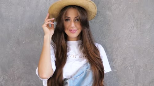 Fashionable Woman with Hat Posing Indoors