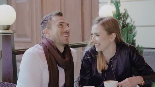 Couple Drinking Coffee On Date At Cafe Outdoors