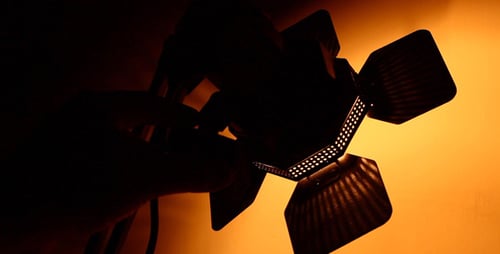 Hand Adjusting Moody Photography Light at Night