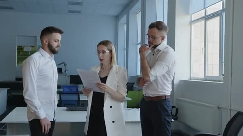 Business Team Meeting Discussing Documents in Office