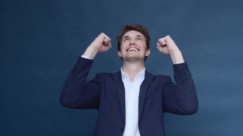 Handsome Man in Business Suit Showing His Excitement While Inside the Studio