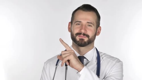Bearded Doctor Points to Side While Smiling