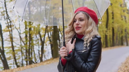 Woman with Umbrella in Autumn Park