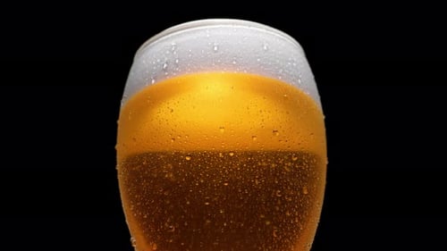 Close-up beer in glass. Slow Motion.