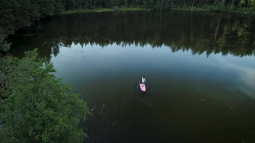 Traveler Exploring Lake In Wild Forest