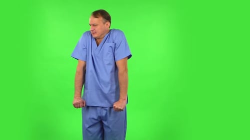 Un médecin s'est figé et a essayé de se réchauffer contre un écran vert.