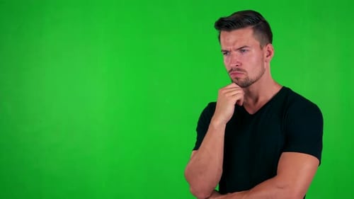 Young Handsome Caucasian Man Thinks About Something - Green Screen - Studio