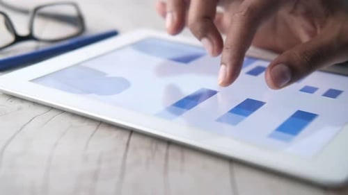 Man's Hand Working on Digital Tablet at Office Desk, Using Self Created Chart