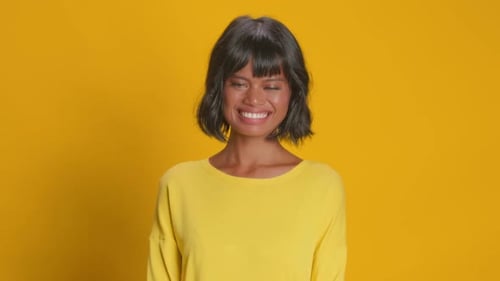 Smiling Woman Posing Against Yellow Background