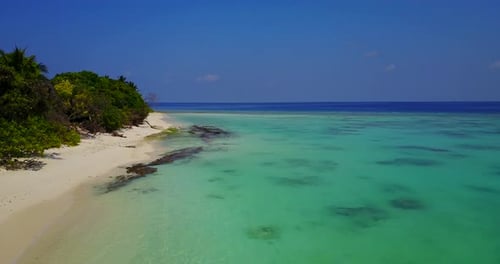Wide angle fly over abstract shot of a white sand paradise beach and turquoise sea background in col