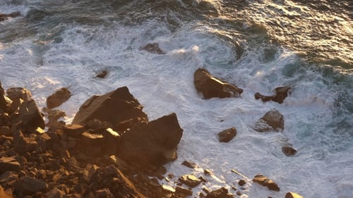Relaxing ocean waves crashing into rocky shore.